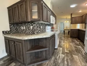 Kitchen with dark wood cabinets, mosaic tile backsplash and plank-style flooring