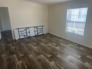Living room with large window and wood-look flooring